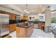 Spacious kitchen with tile floors, wood cabinets, stainless steel appliances, and a center island at 3037 Crest Dr, Clearwater, FL 33759