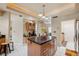 Updated kitchen with granite countertops, tile flooring, central island and custom lighting at 3037 Crest Dr, Clearwater, FL 33759