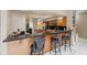 Kitchen bar with three stools and granite counters, next to wood cabinets and stainless appliances at 3037 Crest Dr, Clearwater, FL 33759