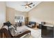 Relaxing den space featuring a lounge sofa, natural light, and fan at 3037 Crest Dr, Clearwater, FL 33759