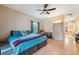Spacious main bedroom features wood-look floors, a ceiling fan, and a cozy armchair at 3037 Crest Dr, Clearwater, FL 33759