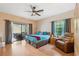 Comfortable main bedroom features a sliding glass door to the patio, and neutral paint at 3037 Crest Dr, Clearwater, FL 33759