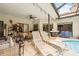Covered patio area with ceiling fans, a grill, and lounge chairs by the pool at 3037 Crest Dr, Clearwater, FL 33759