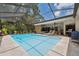 Relaxing screened-in pool area with sun loungers and a view of the blue water at 3037 Crest Dr, Clearwater, FL 33759