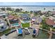 Aerial view of a waterfront home with a pool, boat dock, and beautifully landscaped backyard at 311 22Nd St, Belleair Beach, FL 33786