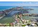 Aerial view of waterfront homes on a peninsula with city skyline in the background at 311 22Nd St, Belleair Beach, FL 33786