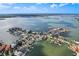 Aerial view of waterfront homes in a residential neighborhood with private boat docks at 311 22Nd St, Belleair Beach, FL 33786