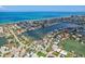 An aerial view of a waterside neighborhood featuring waterfront homes and lush landscaping at 311 22Nd St, Belleair Beach, FL 33786