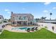 Lush backyard with a sparkling pool, patio seating, and manicured landscaping at 311 22Nd St, Belleair Beach, FL 33786