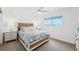 Bright bedroom featuring beach-themed decor, a ceiling fan, and natural light from the window at 311 22Nd St, Belleair Beach, FL 33786