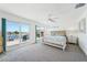 Bright bedroom with sliding glass doors to the deck and coastal decor accents at 311 22Nd St, Belleair Beach, FL 33786