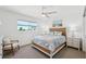 Bright bedroom featuring a ceiling fan, matching nightstands and coastal style decor at 311 22Nd St, Belleair Beach, FL 33786