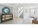 Bright entryway featuring stylish decor, a staircase, and a door leading outside at 311 22Nd St, Belleair Beach, FL 33786
