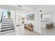 Inviting entryway with stairs, bench, and a view into the kitchen at 311 22Nd St, Belleair Beach, FL 33786