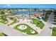 Aerial view of an upscale neighborhood, highlighting a stunning two-story home with manicured lawns and lush landscaping at 311 22Nd St, Belleair Beach, FL 33786