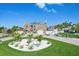 Stunning two-story home with a circular driveway, lush landscaping, and a well-manicured lawn on a bright day at 311 22Nd St, Belleair Beach, FL 33786