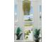 Bright foyer with high ceilings, modern chandelier, and views of lush landscaping at 311 22Nd St, Belleair Beach, FL 33786