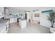 Open kitchen with stainless steel appliances, marble countertops, and ample natural light at 311 22Nd St, Belleair Beach, FL 33786