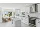 Bright kitchen features white cabinets, stainless steel appliances, granite counters, and an eat-in area with bay window at 311 22Nd St, Belleair Beach, FL 33786