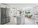 Modern kitchen featuring white cabinets, a stainless steel refrigerator, and a marble island at 311 22Nd St, Belleair Beach, FL 33786