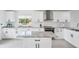 Stylish kitchen featuring white cabinets, marble countertops, and stainless steel appliances at 311 22Nd St, Belleair Beach, FL 33786