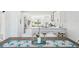 Open concept kitchen features white cabinets, granite countertops, stainless appliances, breakfast bar, and dining area at 311 22Nd St, Belleair Beach, FL 33786