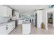Spacious white kitchen features an island, stainless steel appliances, granite countertops, and an open view to the water at 311 22Nd St, Belleair Beach, FL 33786