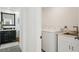 Laundry area with side-by-side washer and dryer, and a sink with modern fixtures at 311 22Nd St, Belleair Beach, FL 33786