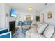 Bright living room with a fireplace, comfortable seating, and lots of natural light at 311 22Nd St, Belleair Beach, FL 33786
