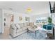Bright living room featuring comfortable seating, fireplace, and view of the canal at 311 22Nd St, Belleair Beach, FL 33786