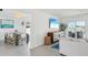 Open living space with dining area, modern cabinet, and a sliding glass door to an outdoor area with water view at 311 22Nd St, Belleair Beach, FL 33786