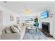 Bright living room with fireplace, comfortable seating, and view of the canal at 311 22Nd St, Belleair Beach, FL 33786