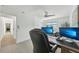 Well-lit office area includes dual monitors and leads to other parts of the home at 311 22Nd St, Belleair Beach, FL 33786