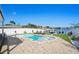 Stunning pool area with sun loungers, boat dock, and waterfront views at 311 22Nd St, Belleair Beach, FL 33786