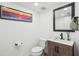 Well-lit powder room with modern vanity, stylish mirror, and neutral decor at 311 22Nd St, Belleair Beach, FL 33786