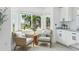 Bright sitting area with large windows, comfortable chairs, and white cabinets at 311 22Nd St, Belleair Beach, FL 33786