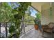 Inviting balcony with trees, tiled flooring, and a wicker rocking chair for relaxing outdoors at 3325 Bayshore Blvd # A31, Tampa, FL 33629