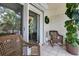 Cozy balcony with tiled flooring, wicker chairs, and sliding glass door with a view of green plants at 3325 Bayshore Blvd # A31, Tampa, FL 33629