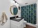 Bathroom with stylish vanity, new fixtures, decorative mirror, and coordinated shower curtain at 3325 Bayshore Blvd # A31, Tampa, FL 33629