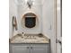 Stylish powder room features a round mirror, granite countertop, and modern lighting fixture at 3325 Bayshore Blvd # A31, Tampa, FL 33629