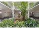 Lush courtyard with mature greenery, benches, and a tiered fountain, creating a tranquil oasis at 3325 Bayshore Blvd # A31, Tampa, FL 33629