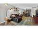 Cozy living room with a large sofa, unique rug, and dining area with bookcase at 3325 Bayshore Blvd # A31, Tampa, FL 33629