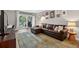 Comfortable living room with sliding doors to balcony, leather couch, and wood floors at 3325 Bayshore Blvd # A31, Tampa, FL 33629