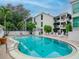 Refreshing community pool surrounded by lounge chairs and lush landscaping near residential buildings at 3325 Bayshore Blvd # A31, Tampa, FL 33629