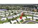 Aerial view of the white roofed home in a well-maintained neighborhood near a lake at 3515 100Th N Ter, Pinellas Park, FL 33782