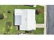 Drone shot of house featuring a white roof, lush lawn and mature landscaping at 3515 100Th N Ter, Pinellas Park, FL 33782