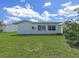 Well-maintained backyard featuring lush green grass and a white house exterior at 3515 100Th N Ter, Pinellas Park, FL 33782