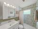 This bathroom features updated cabinets, countertop, lighting, and a shower and tub combo at 3515 100Th N Ter, Pinellas Park, FL 33782