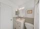 This bathroom features updated cabinets, countertop, lighting, and a medicine cabinet at 3515 100Th N Ter, Pinellas Park, FL 33782