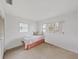Bright bedroom featuring two windows and light carpeting, creating a simple and inviting space at 3515 100Th N Ter, Pinellas Park, FL 33782